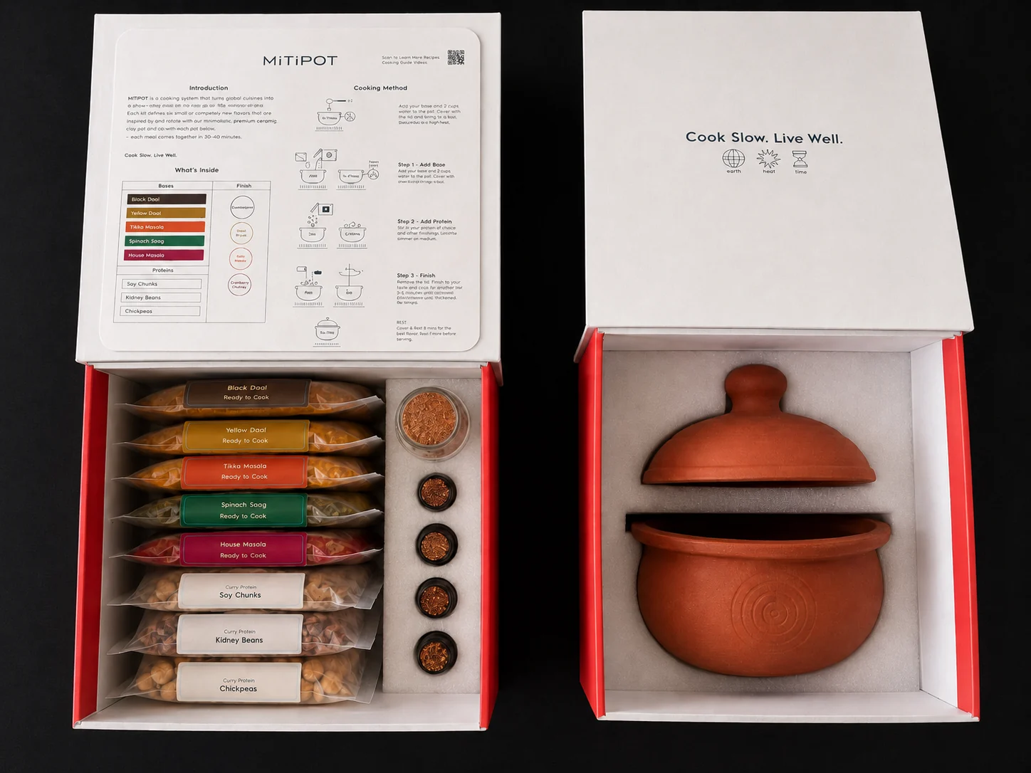 The First Fire boxes open — ingredient box with the five bases, three proteins, four tadkas and Bloomasala, and the pot box with the handmade Mitipot