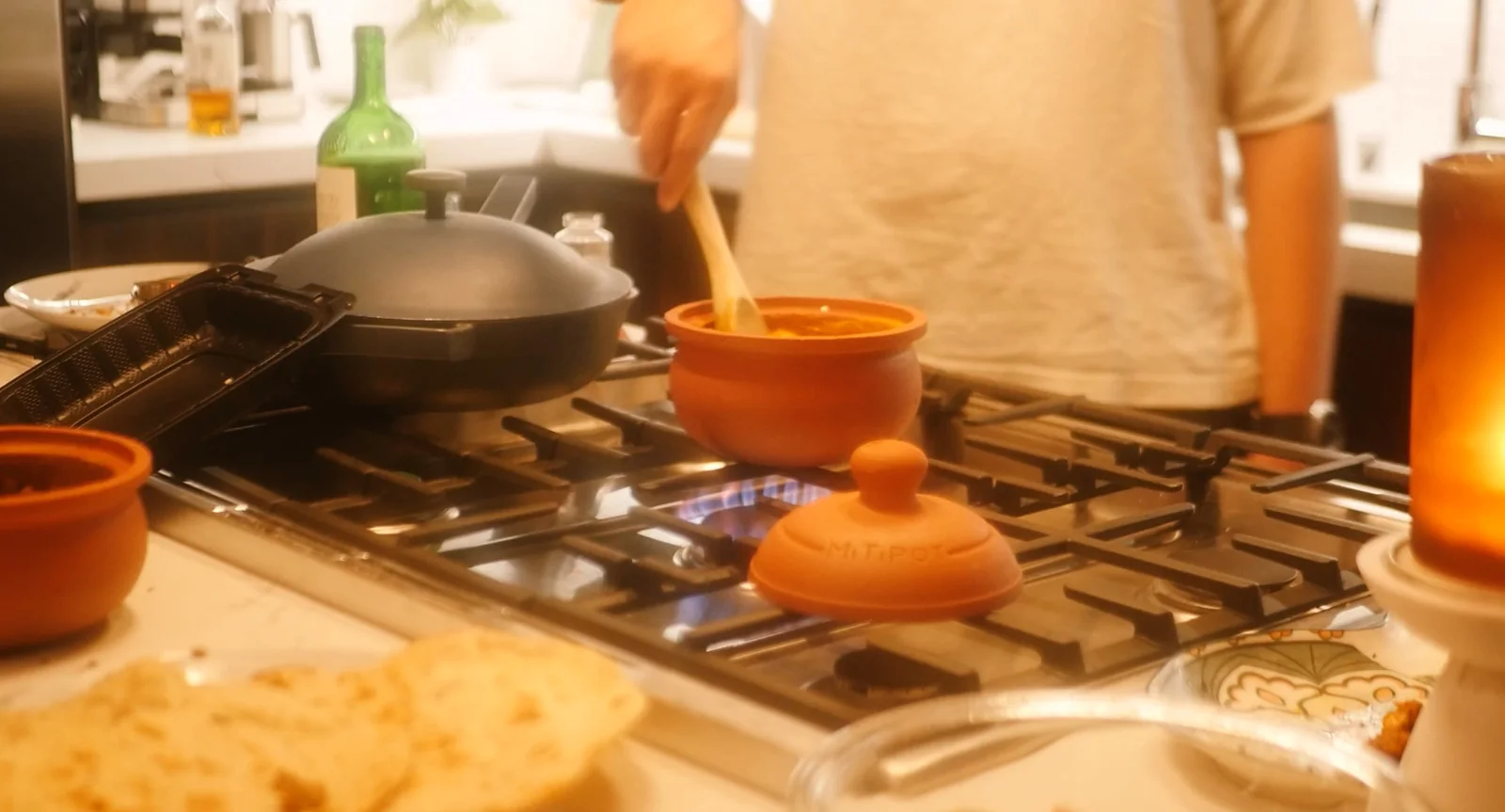 Friends around the pot as the lid comes off