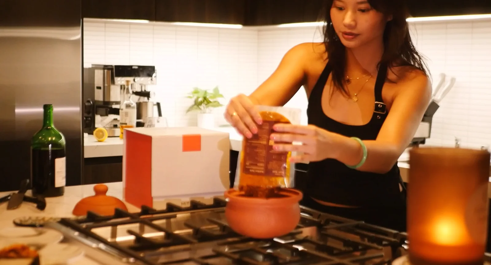 Pouring a base into the Mitipot on a gas stove